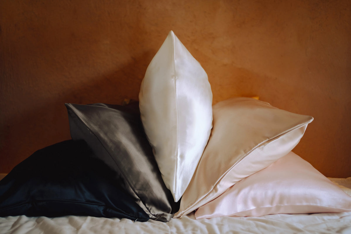 mixed range silk pillowcases on bed