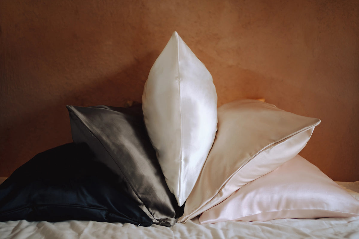 Mixed pillowcase colours against wall